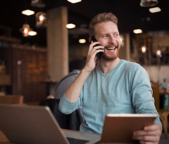 Someone taking a call at their desk, part-way through a check-in.